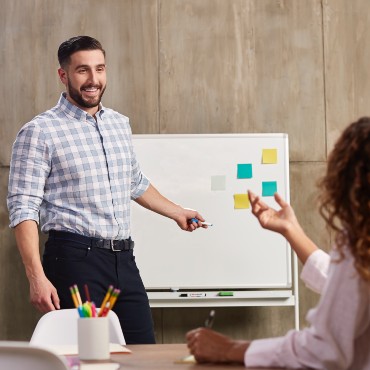 Happy business owner in an engaging meeting with employees