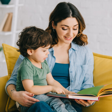 mother reading to son in her lap