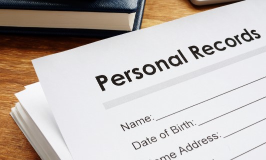 Stack of personal records on a desk